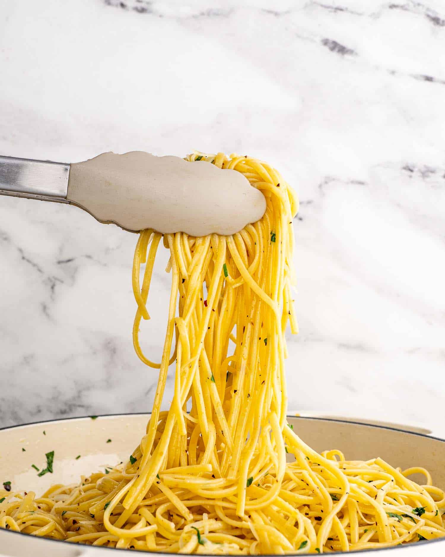 freshly made aglio e olio in a dutch oven braiser.