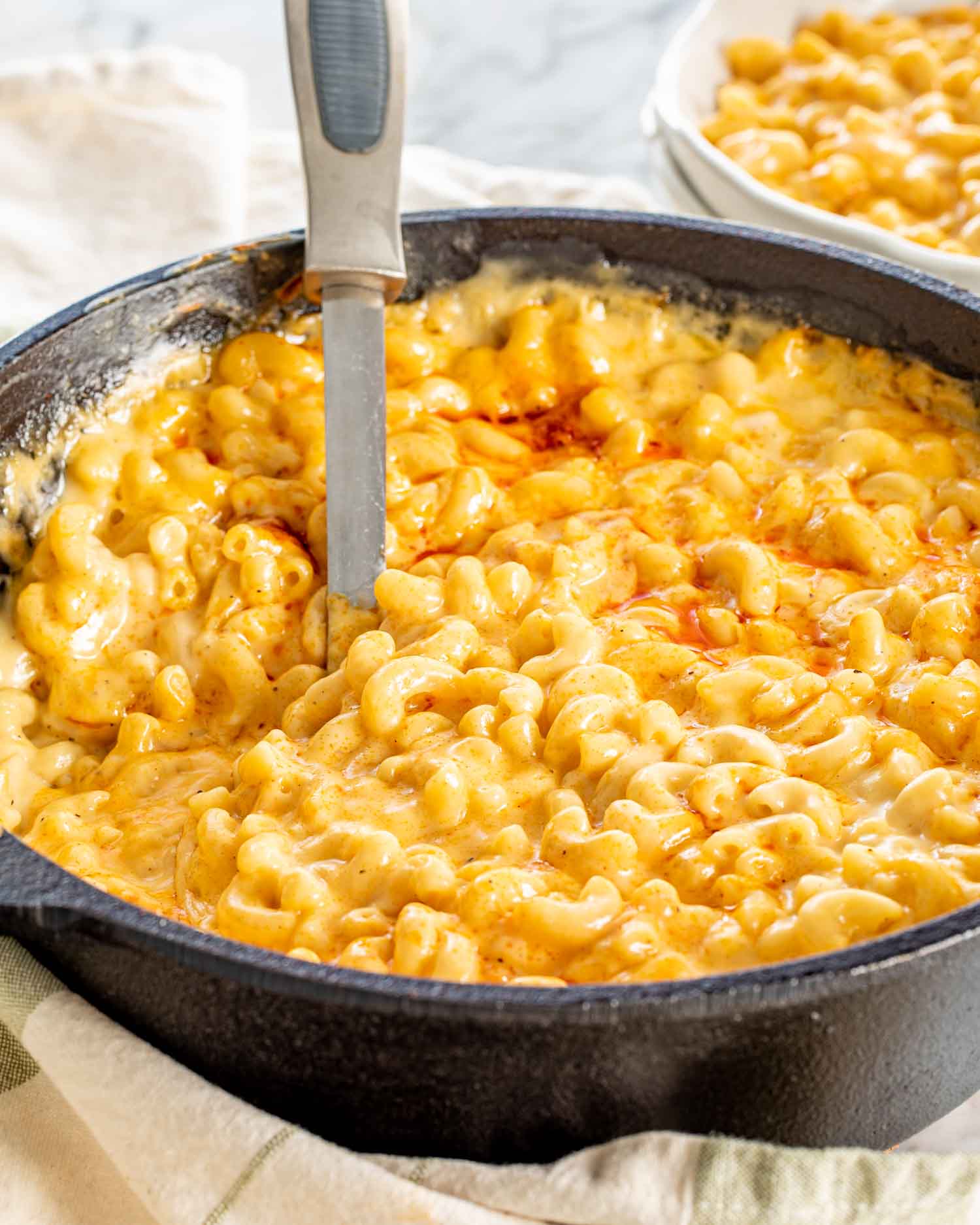 baked mac and cheese in a black cast iron skillet.