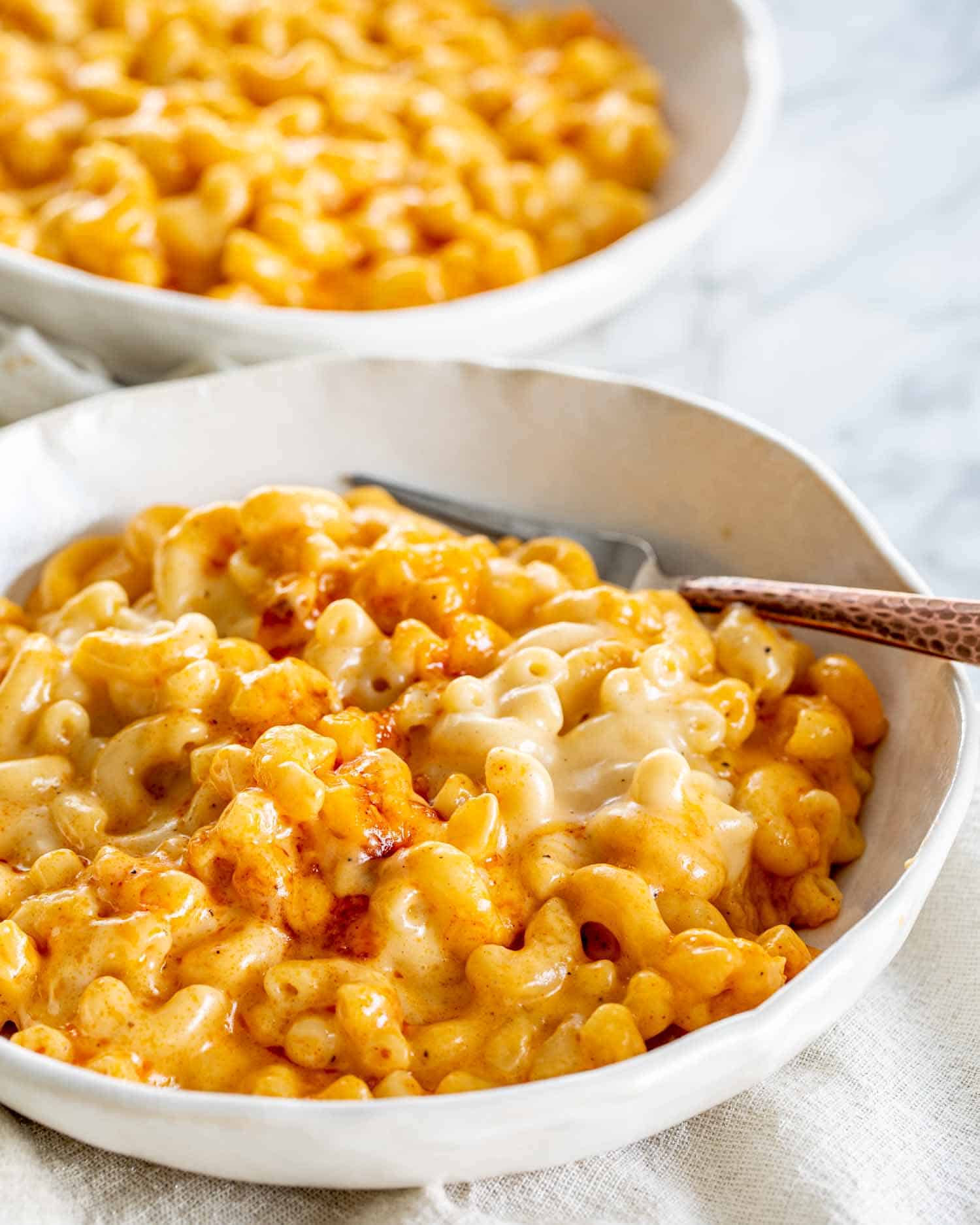 baked mac and cheese in a white plate.