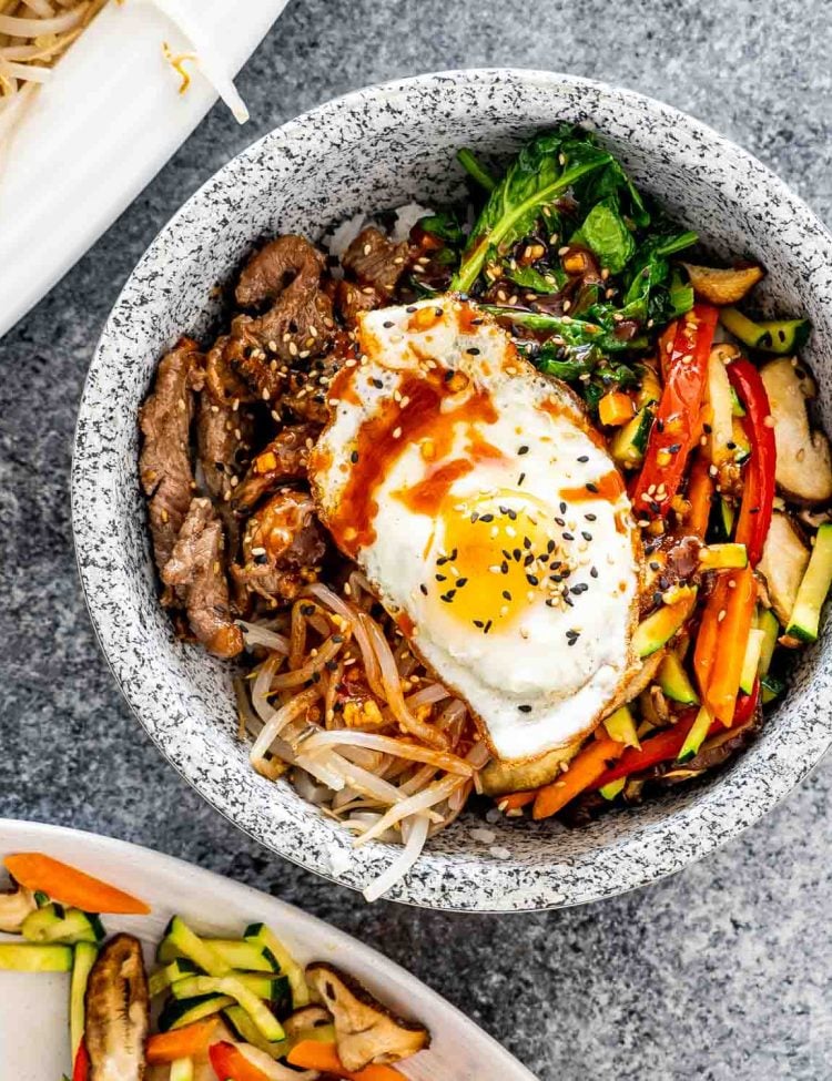 bibimbap with an egg in a bibimbap bowl.