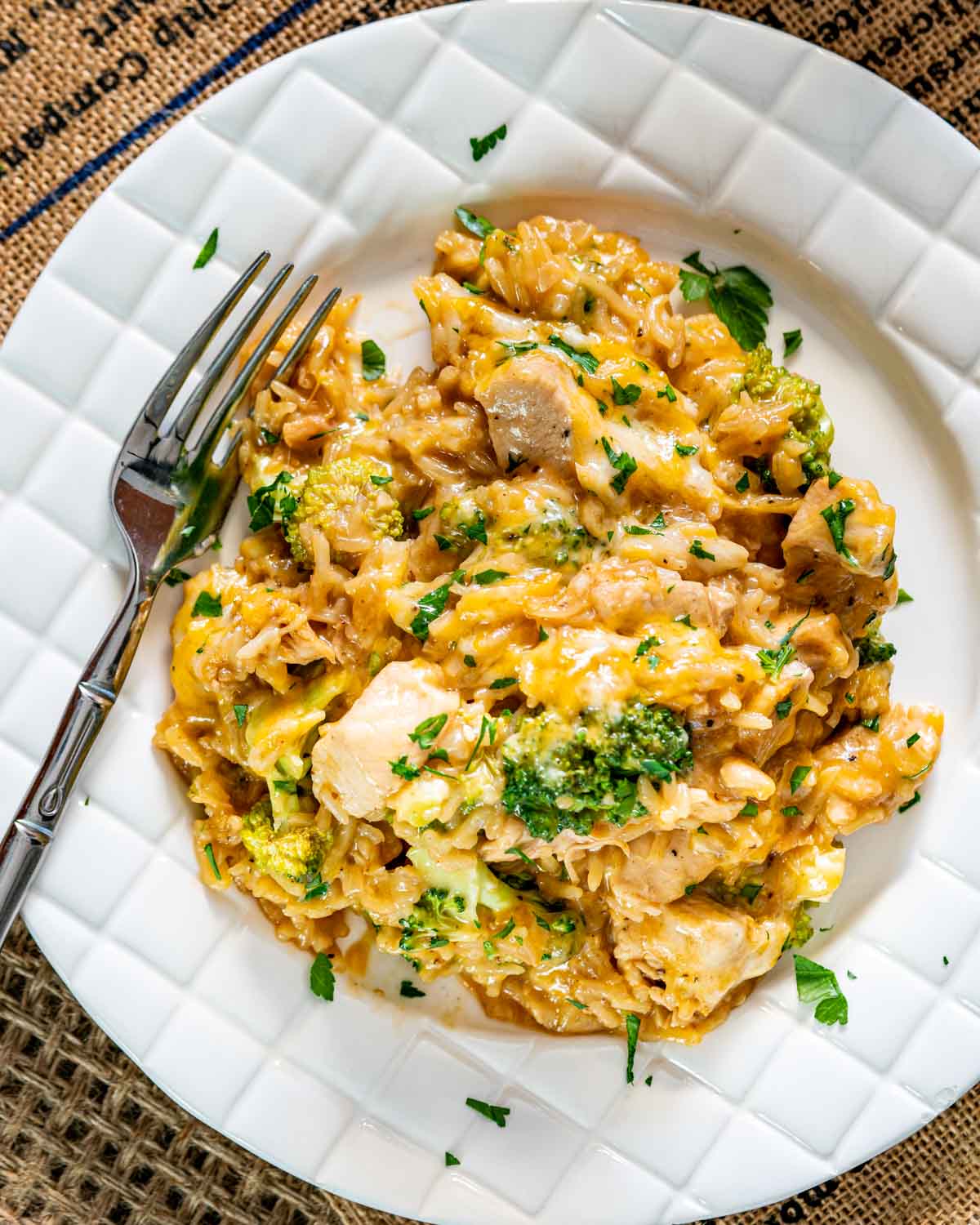a serving of chicken broccoli rice casserole on a white plate.