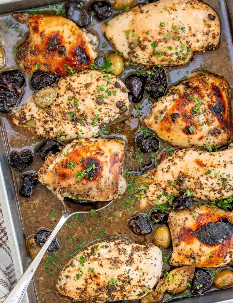 chicken marbella in a baking dish fresh out of the oven.