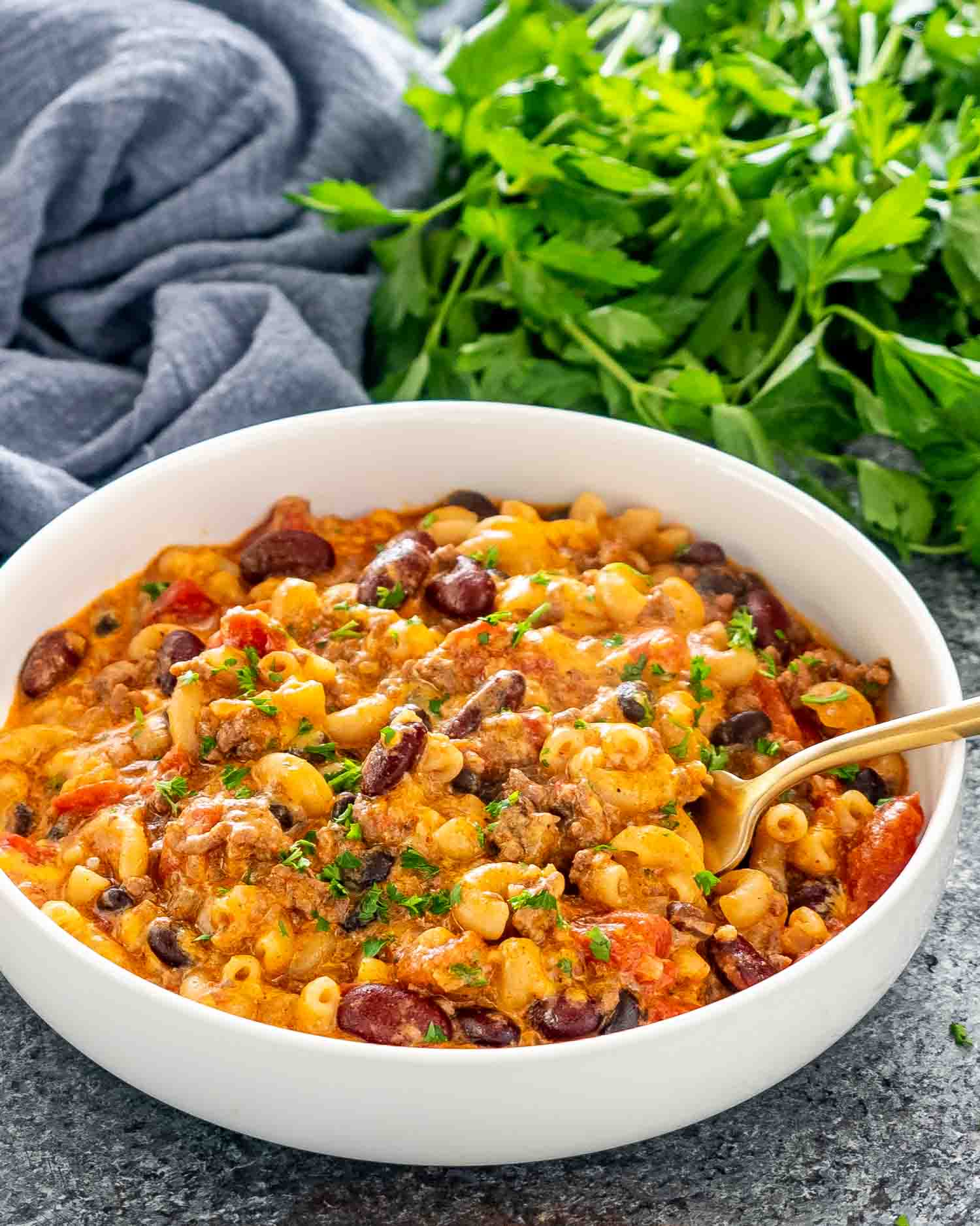 a serving of chili mac and cheese in a white bowl.