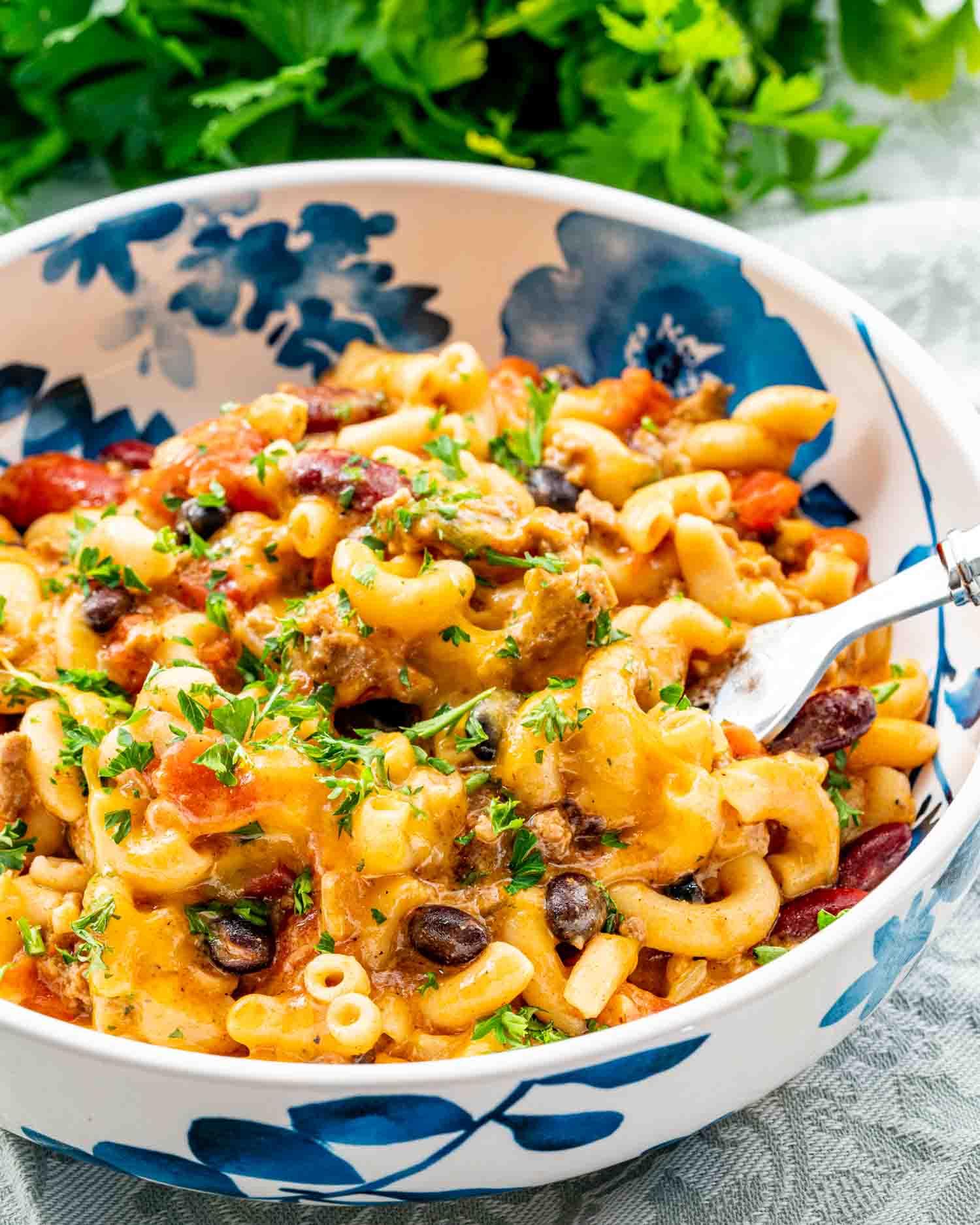 a serving of chili mac and cheese in a white bowl.