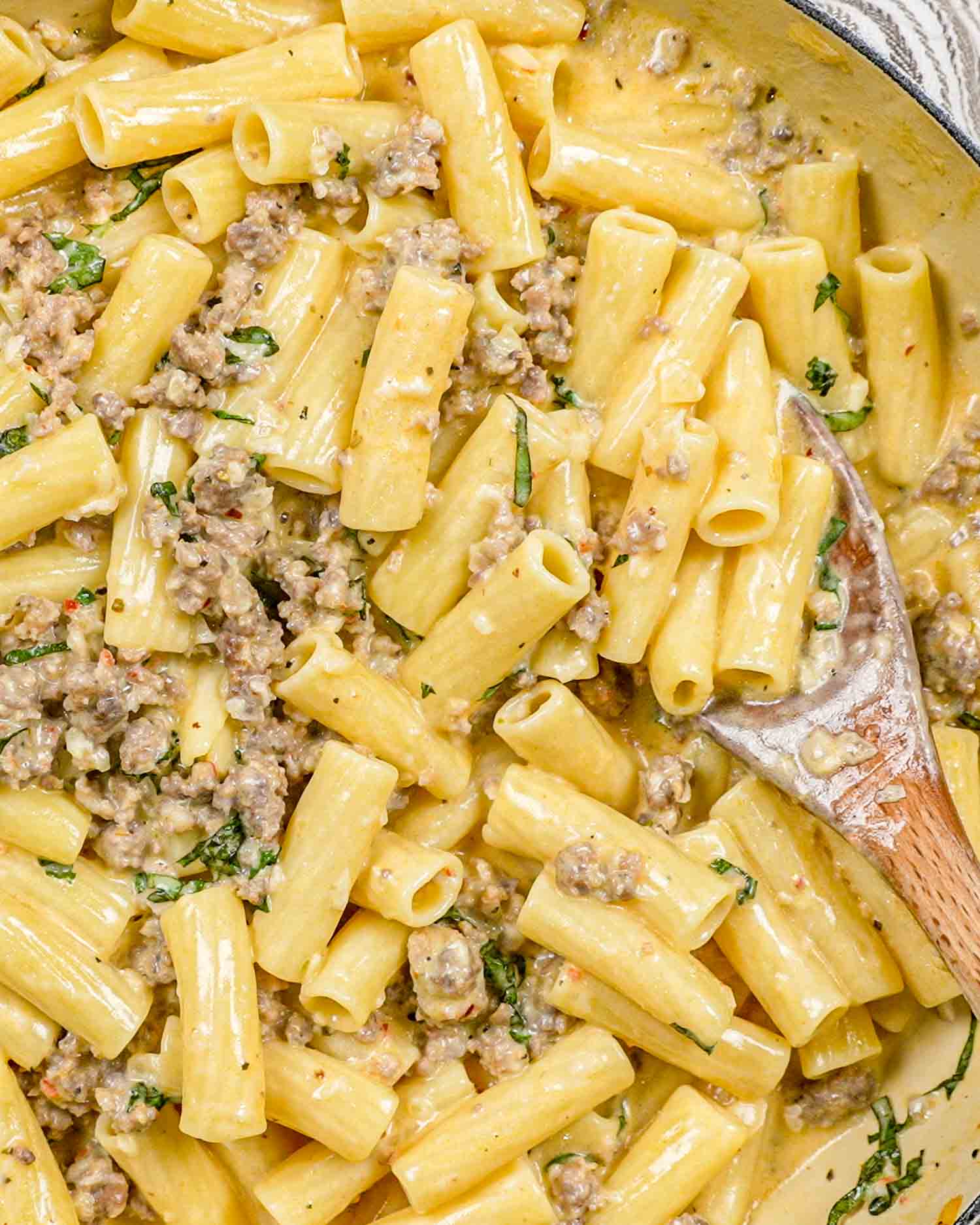 creamy italian sausage pasta in a dutch oven.