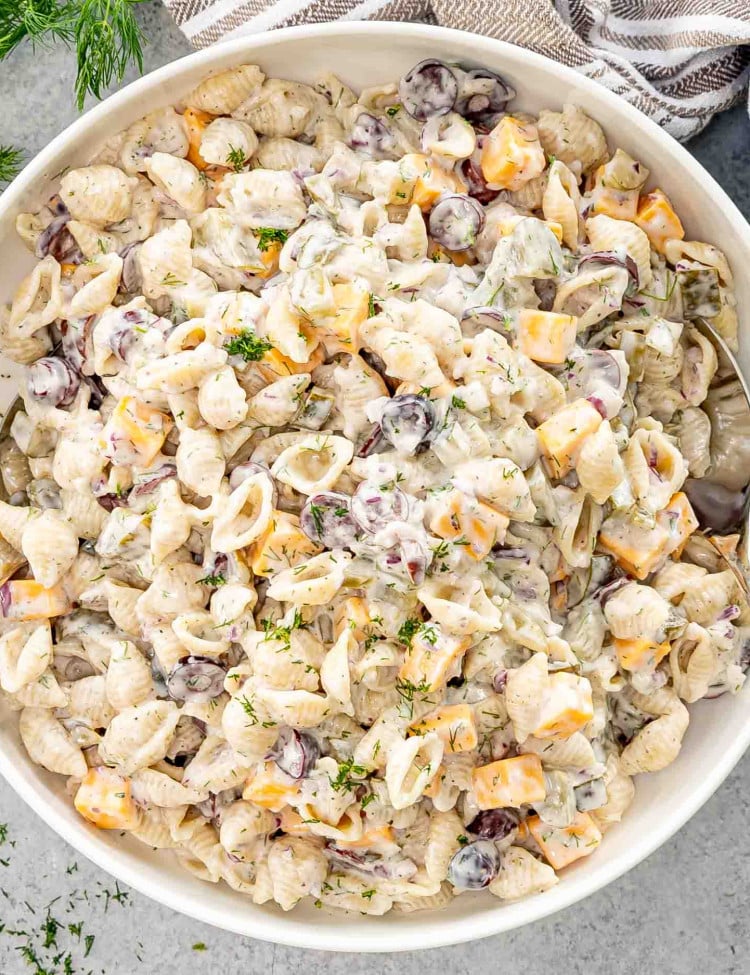 freshly made dill pickle pasta salad in a large white bowl.