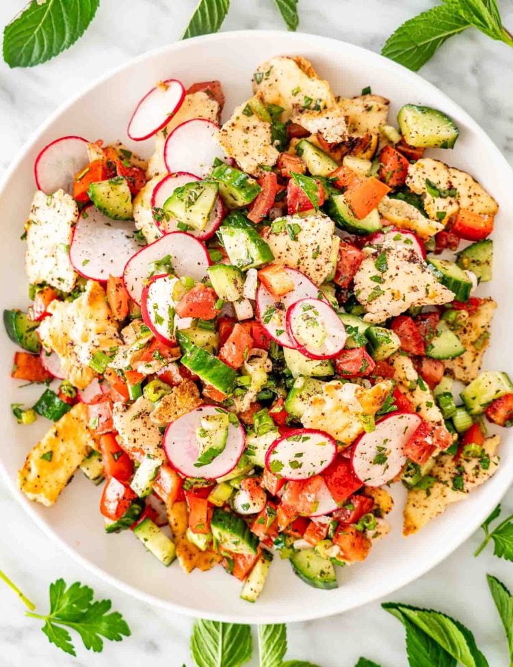 freshly made, crisp fattoush salad in a white bowl.