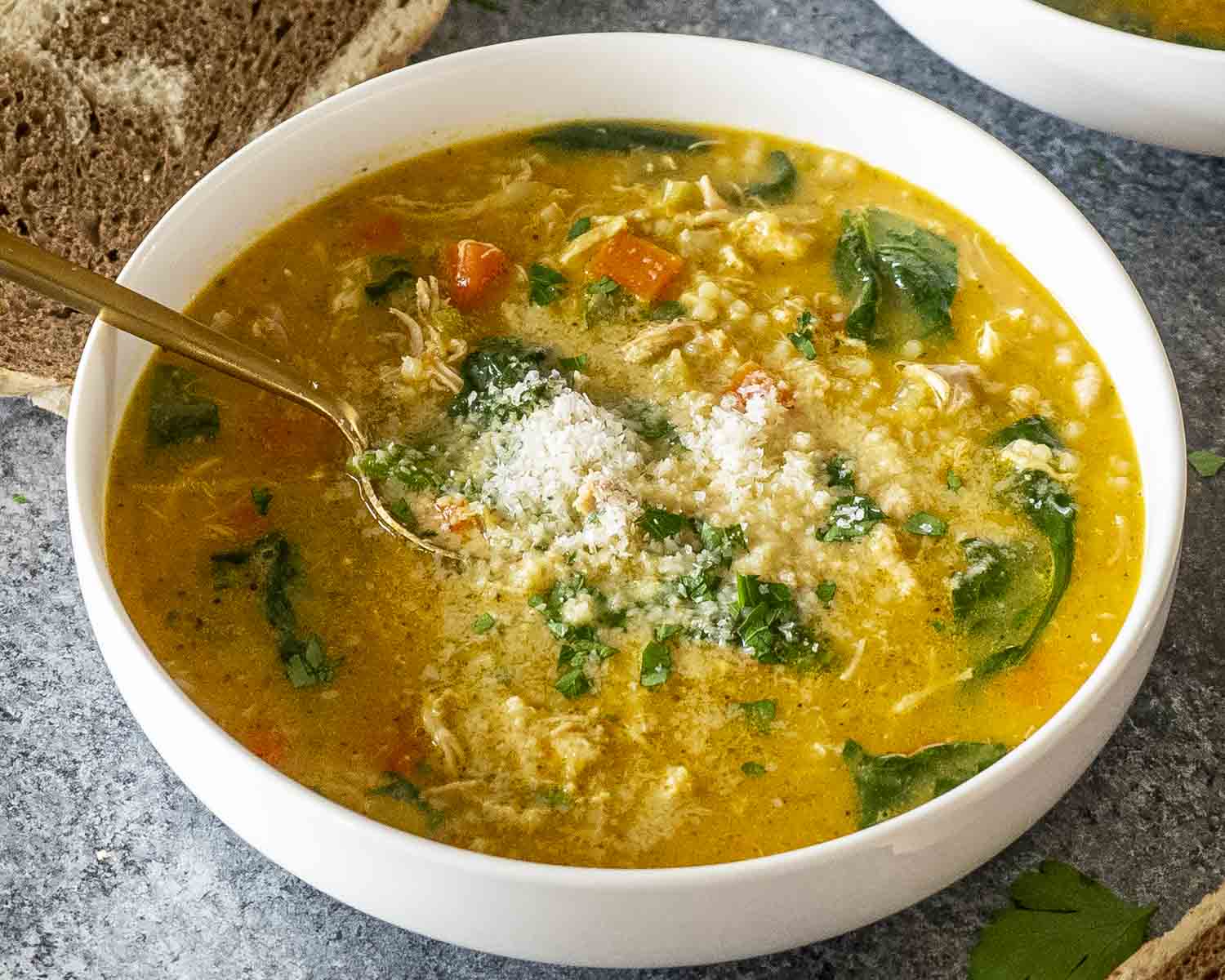 Warm bowl of Italian Penicillin Soup with chicken, ditalini, spinach, and Parmesan cheese, ready to serve with bread slices. Would you like me to also create the Pinterest descriptor set (3-word hook, 1-line description, and hashtags) to go with these images next?