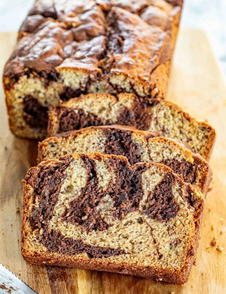 sliced marbled chocolate banana bread on a cutting board.