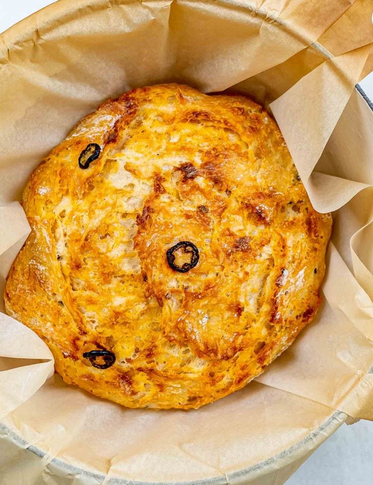 no knead jalapeno cheddar bread in a dutch oven fresh out of the oven.