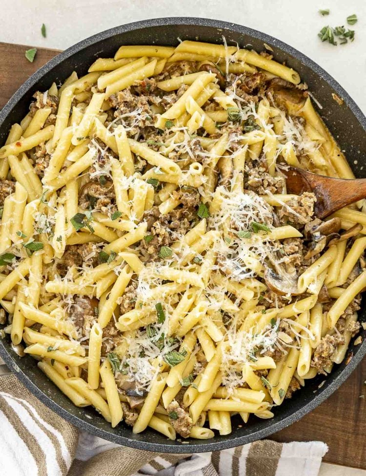 Large skillet filled with Pasta alla Norcina, sprinkled with sage and cheese, ready to serve.