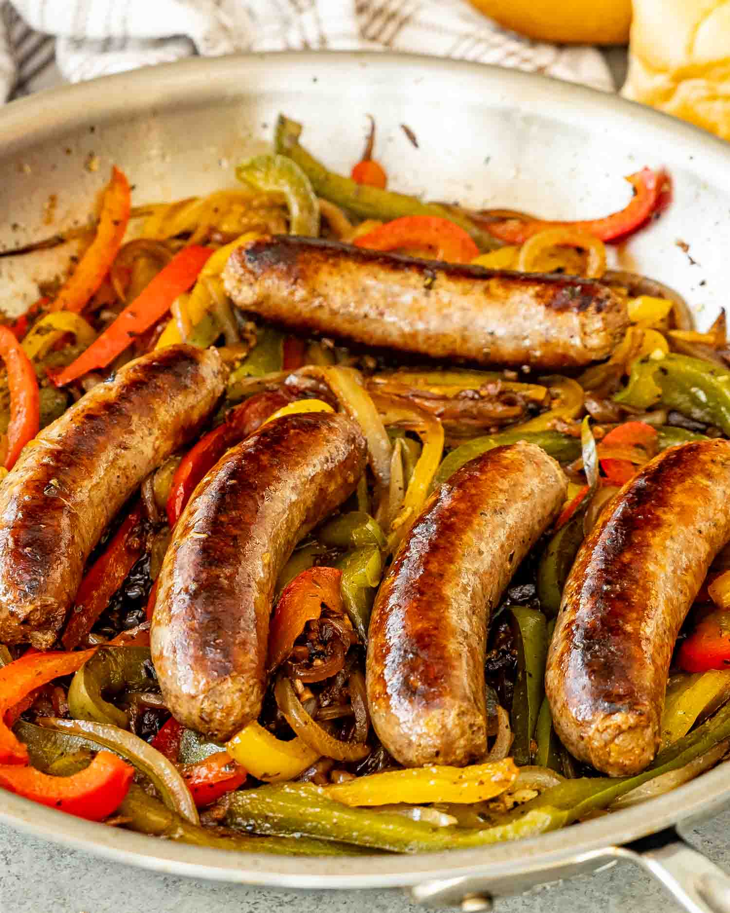 sausage peppers and onions in a skillet.