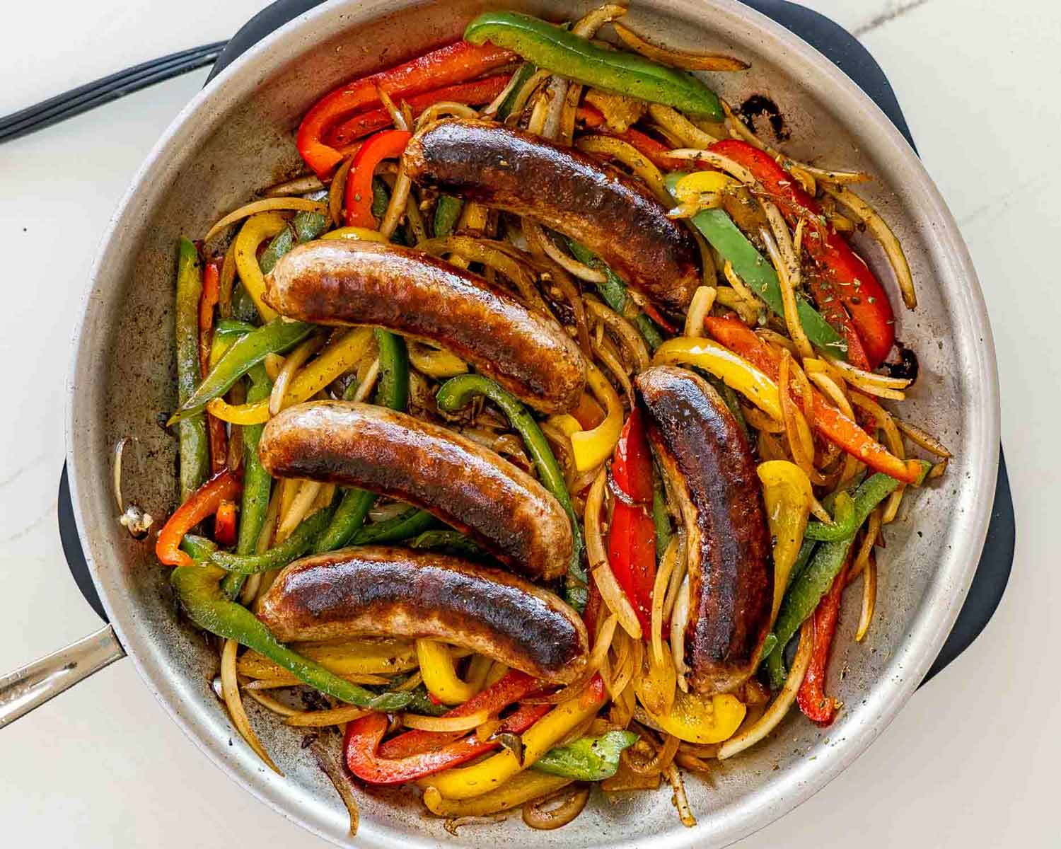 process shots showing how to make sausage peppers and onions.