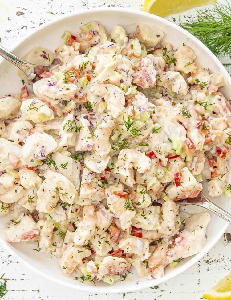 freshly made seafood salad in a white bowl.